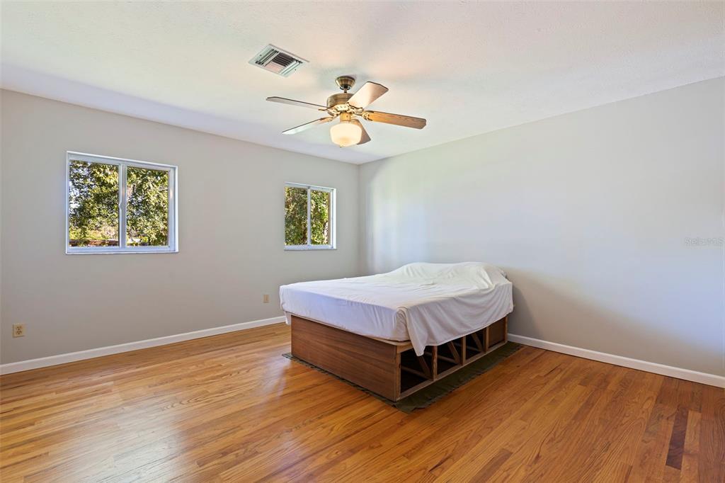 8609 Stoner Road Riverview, FL 33569 - Photo 32 of 66 a bedroom with a bed and wooden floor