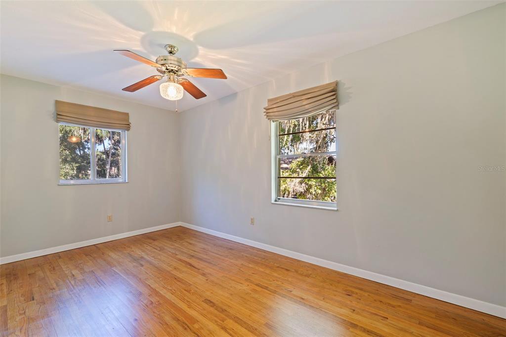 8609 Stoner Road Riverview, FL 33569 - Photo 36 of 66 a view of an empty room with wooden floor and a window