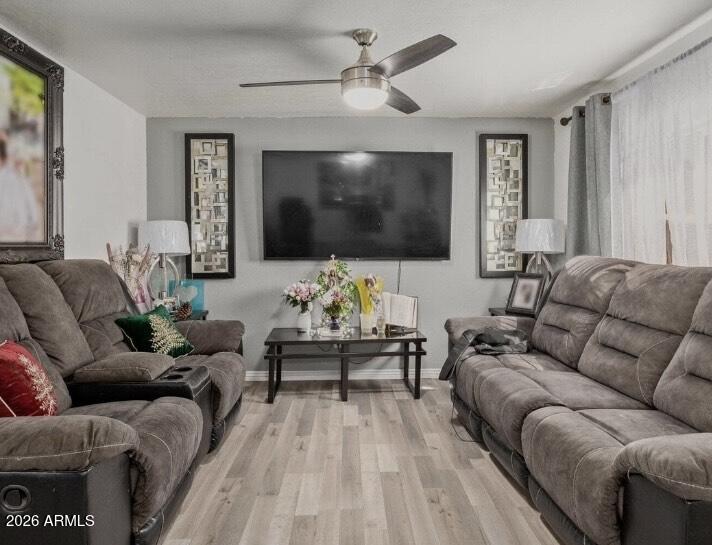 5002 West Bethany Home Road, Unit 104 Glendale, AZ 85301 - Photo 11 of 17 a living room with furniture and a flat screen tv