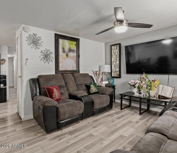 5002 West Bethany Home Road, Unit 104 Glendale, AZ 85301 - Photo 12 of 17 a living room with furniture and a flat screen tv