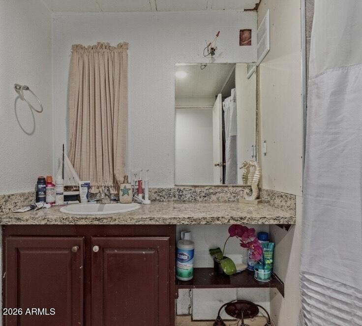 5002 West Bethany Home Road, Unit 104 Glendale, AZ 85301 - Photo 14 of 17 a bathroom with a sink and a mirror