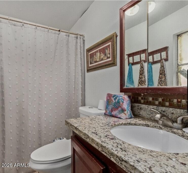 5002 West Bethany Home Road, Unit 104 Glendale, AZ 85301 - Photo 17 of 17 a bathroom with a granite countertop sink and a mirror