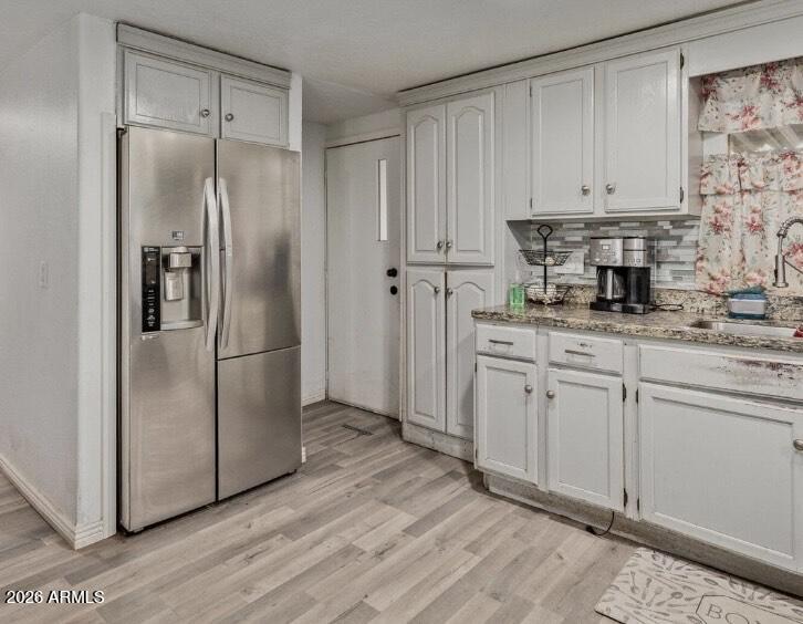 5002 West Bethany Home Road, Unit 104 Glendale, AZ 85301 - Photo 5 of 17 a kitchen with stainless steel appliances granite countertop a refrigerator sink and cabinets