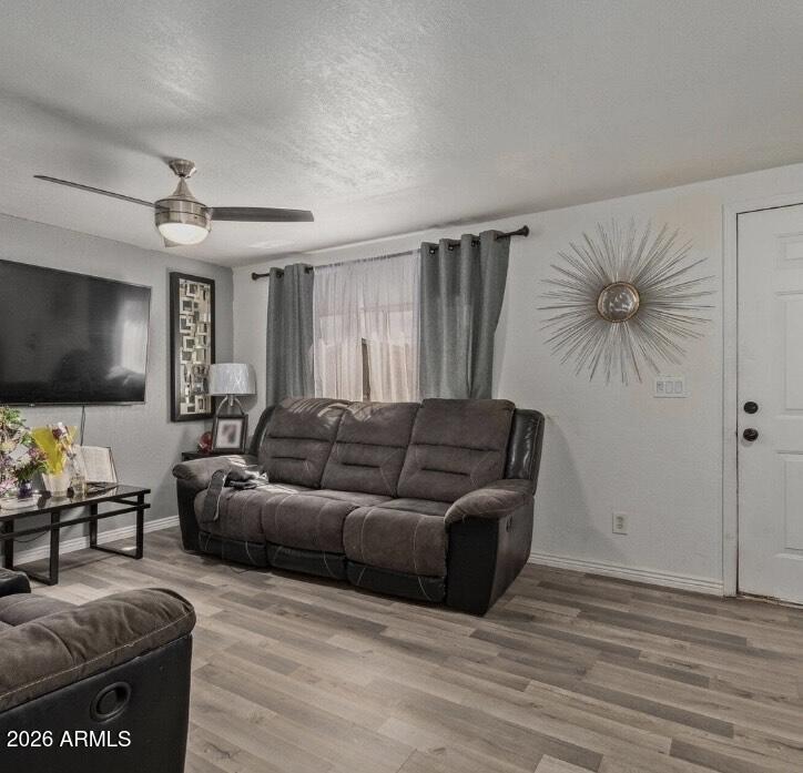 5002 West Bethany Home Road, Unit 104 Glendale, AZ 85301 - Photo 8 of 17 a living room with furniture and a flat screen tv