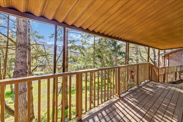 a view of balcony with wooden floor and door