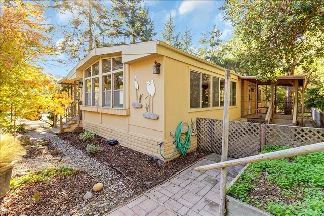 a view of a house with wooden fence