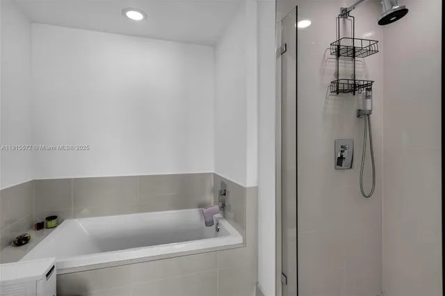a bathroom with a tub and shower