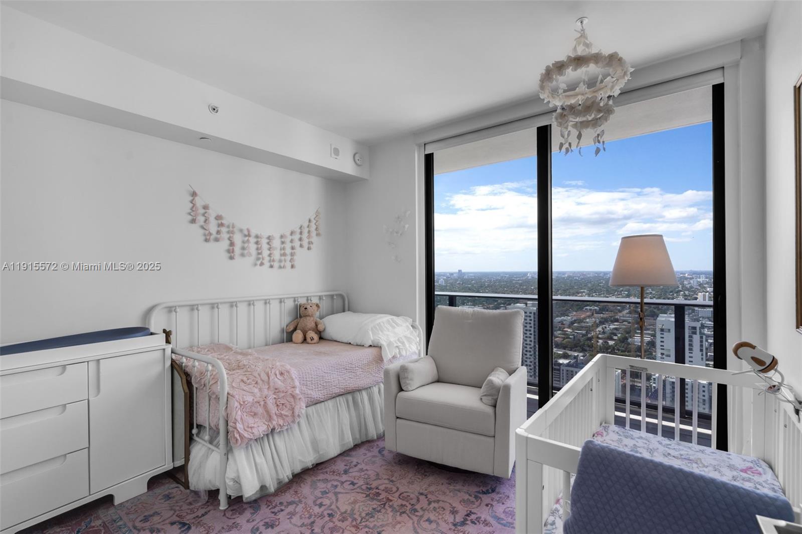 55 Southwest 9th Street, Unit 4008 Miami, FL 33130 - Photo 15 of 36 a bedroom with furniture and a chandelier