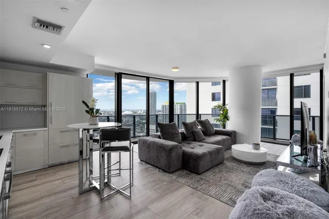 a living room with furniture and a large window