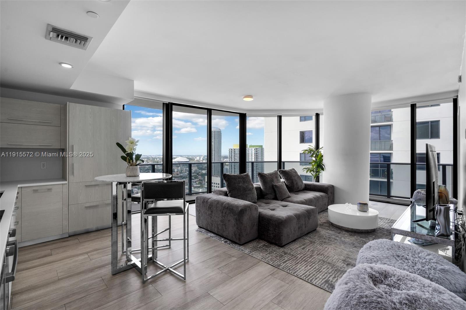 55 Southwest 9th Street, Unit 4008 Miami, FL 33130 - Photo 4 of 36 a living room with furniture and a large window