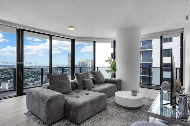 a living room with furniture and a large window
