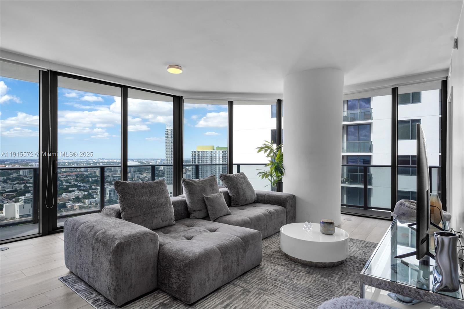 55 Southwest 9th Street, Unit 4008 Miami, FL 33130 - Photo 5 of 36 a living room with furniture and a large window