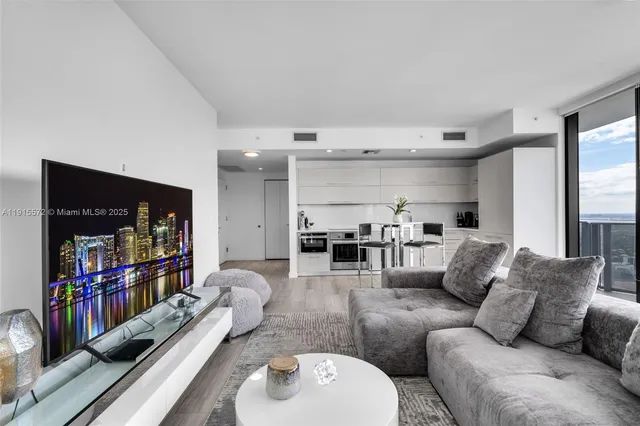 a living room with furniture and a book shelf