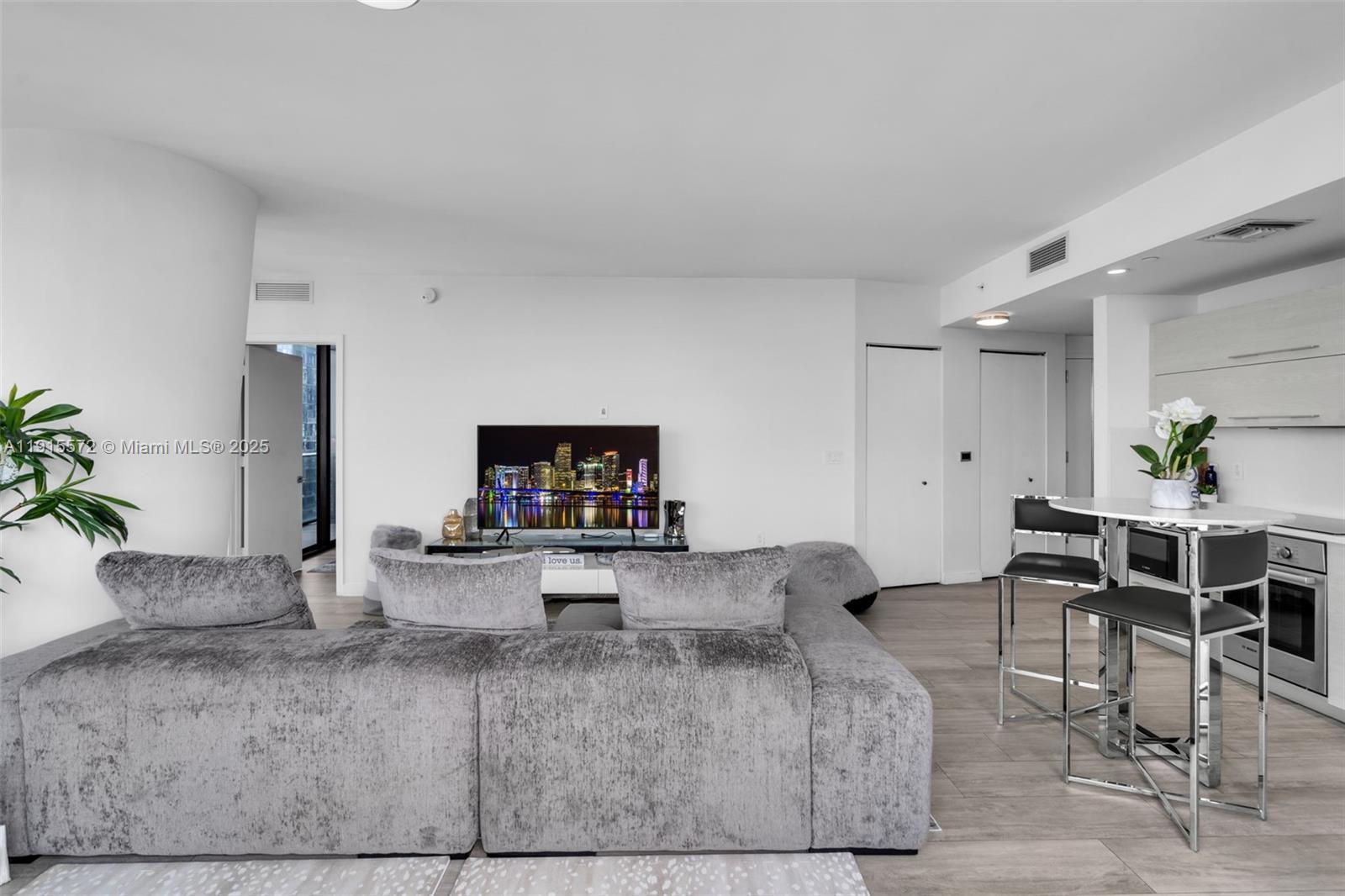 55 Southwest 9th Street, Unit 4008 Miami, FL 33130 - Photo 7 of 36 a living room with furniture and a flat screen tv