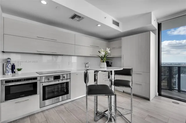 a kitchen with a stove and white cabinets