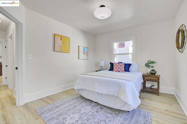 a bed room with a bed mirror and a chair