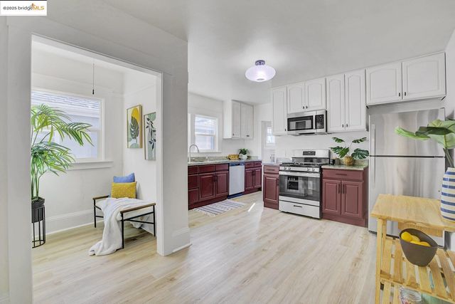 a kitchen with wooden floors and appliances