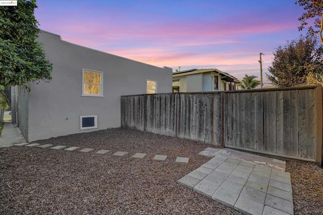 a view of a house with wooden fence