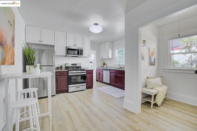 a kitchen with granite countertop a stove top oven microwave and cabinets