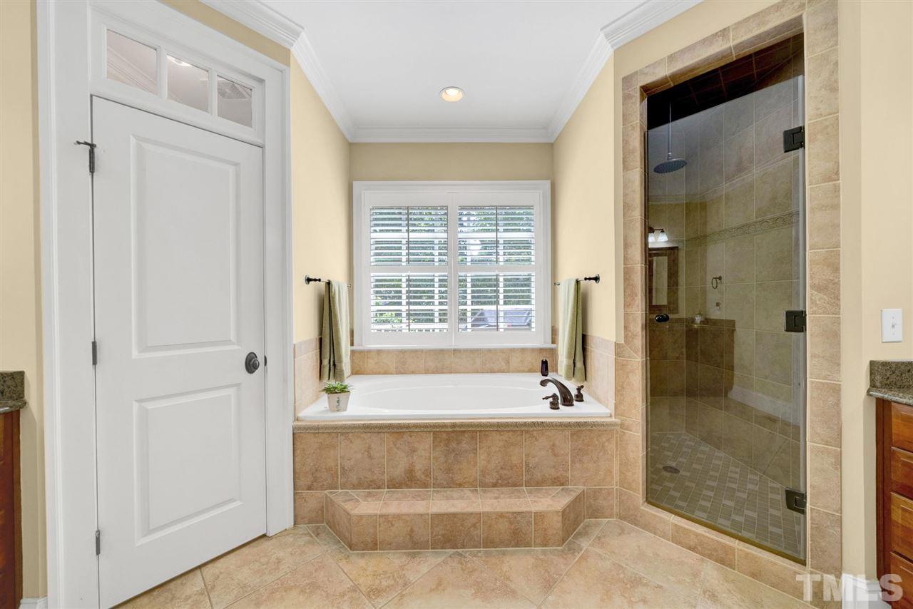 403 Yarmouth Road Raleigh, NC 27608 - Photo 17 of 30 a bathroom with a bathtub and a shower