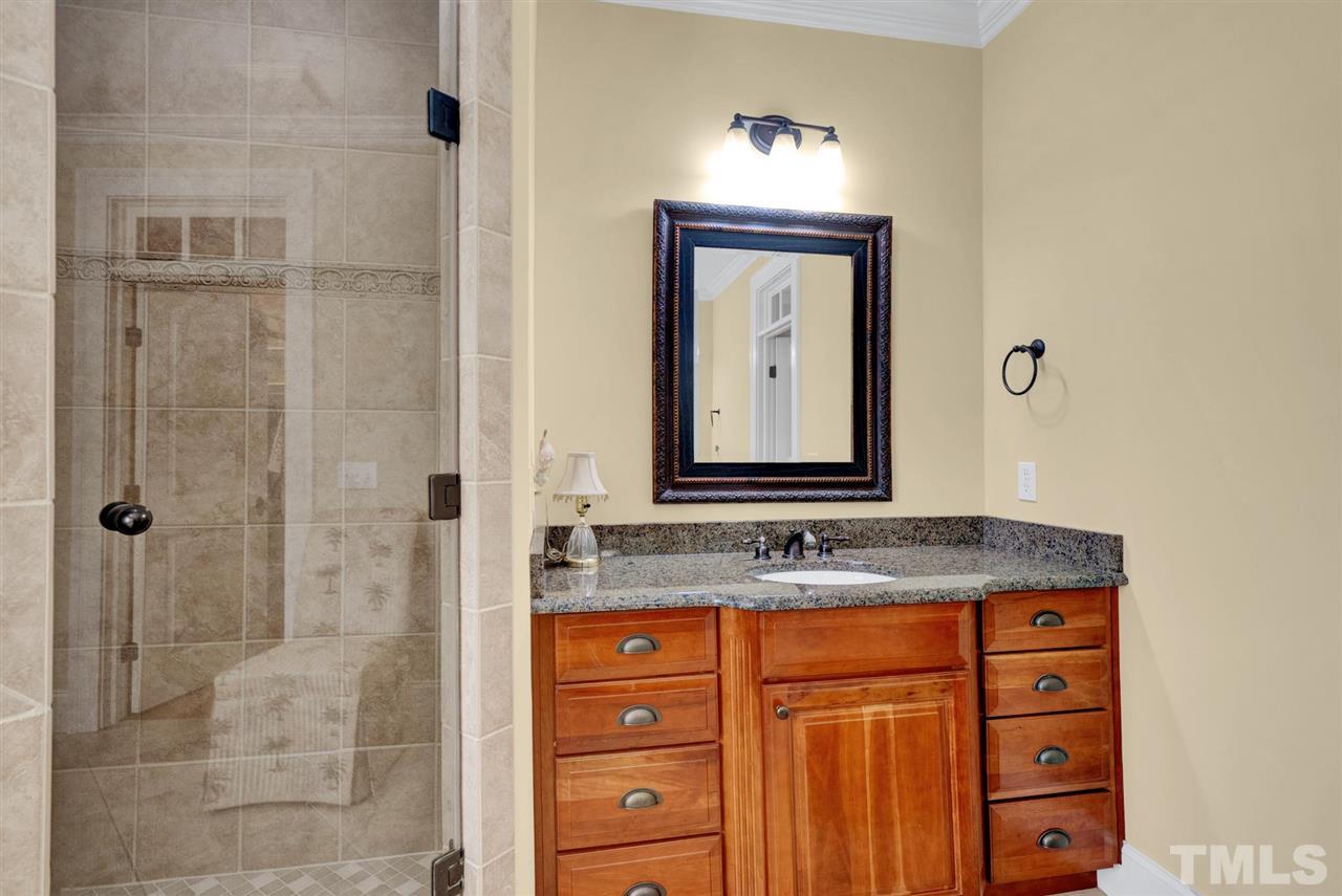 403 Yarmouth Road Raleigh, NC 27608 - Photo 18 of 30 a bathroom with a granite countertop sink a mirror and shower