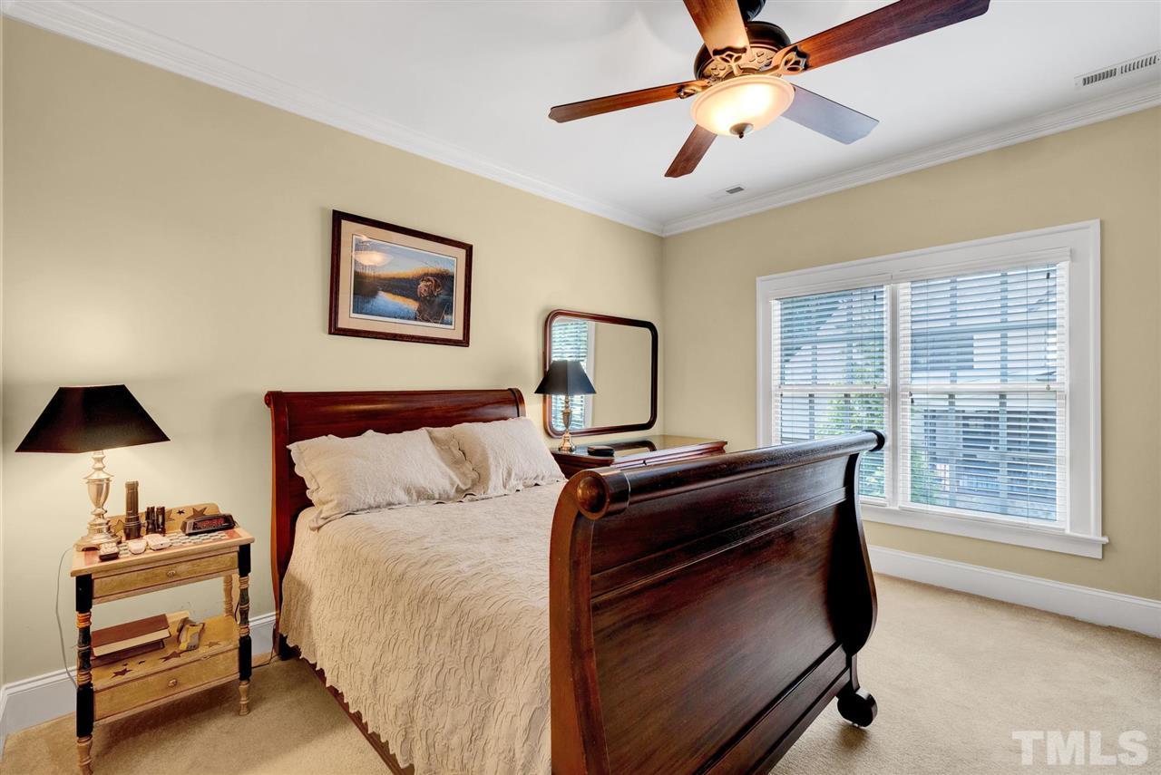 403 Yarmouth Road Raleigh, NC 27608 - Photo 20 of 30 a bed room with a bed and a chandelier