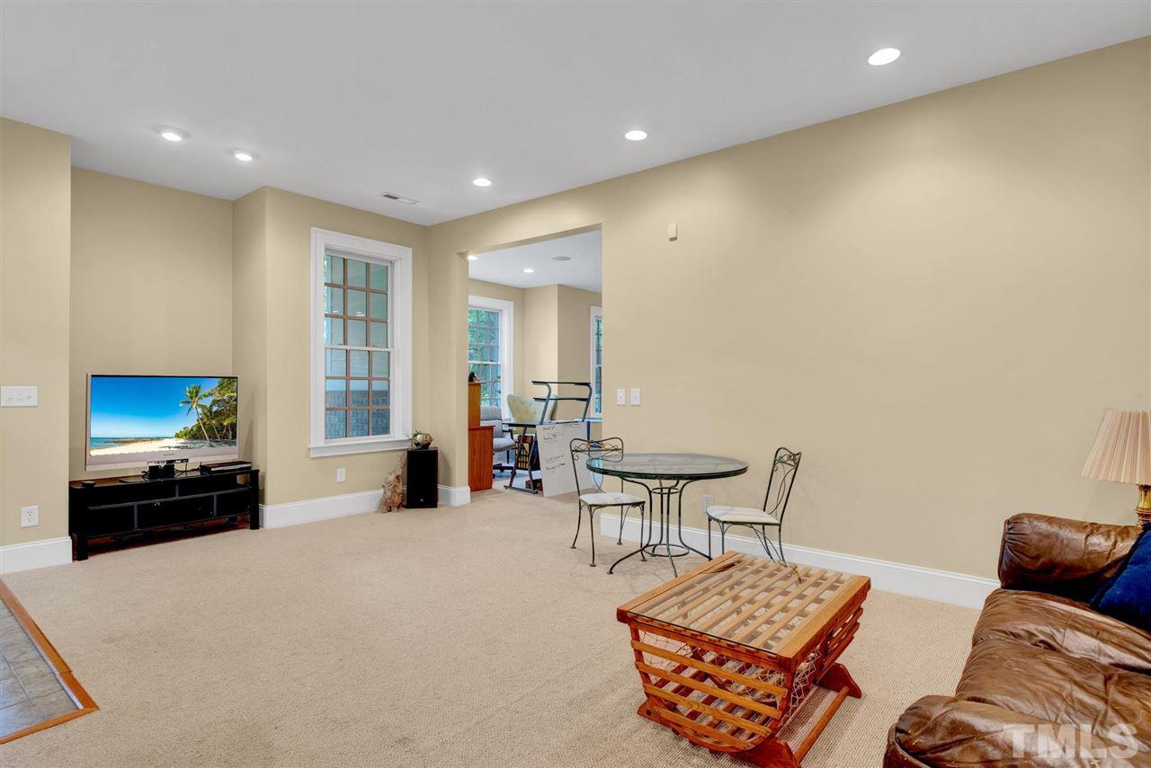 403 Yarmouth Road Raleigh, NC 27608 - Photo 23 of 30 a living room with furniture and a flat screen tv