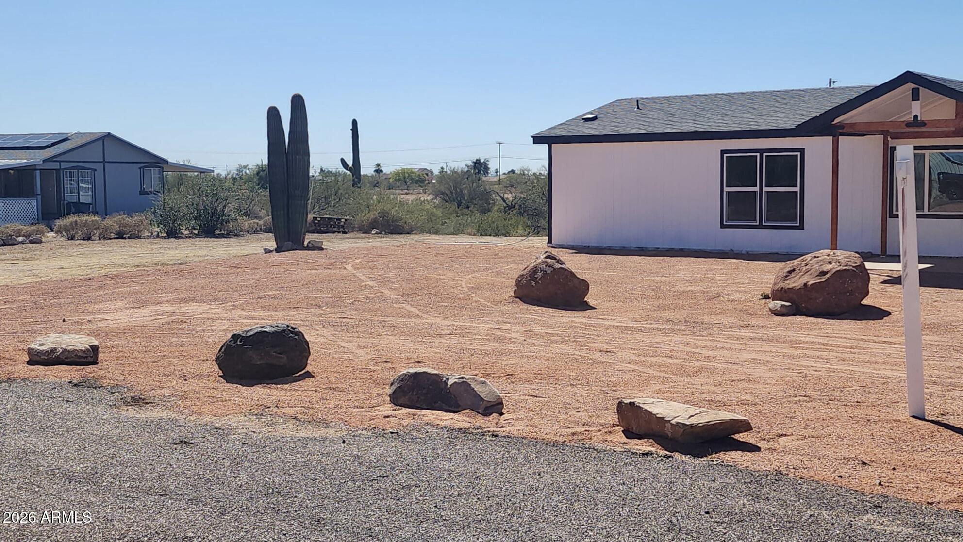 1470 South Bowman Road Apache Junction, AZ 85119 - Photo 10 of 56 a view of a house with backyard and a yard