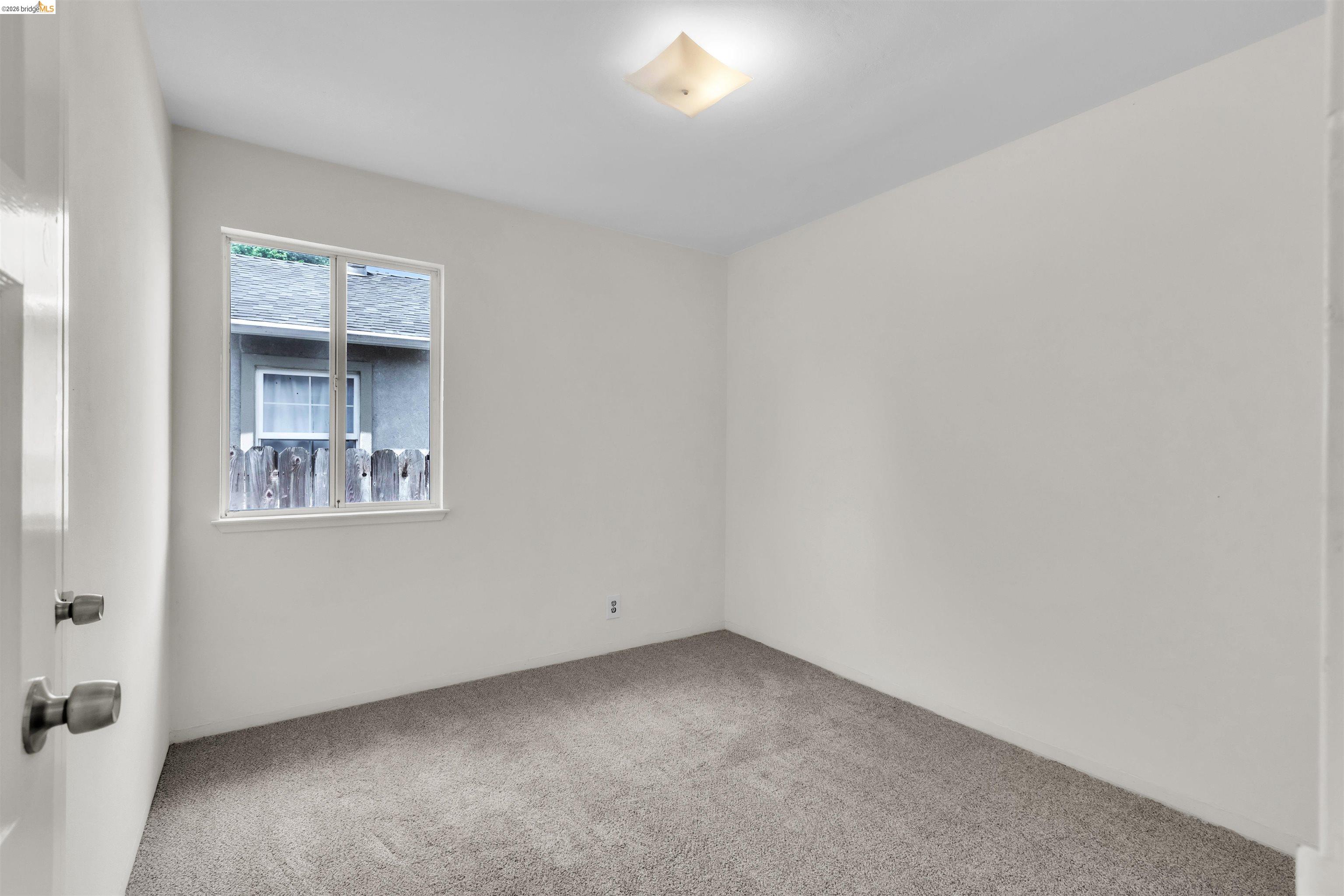 621 Paseo Del Rio San Lorenzo, CA 94580 - Photo 19 of 24 Room featuring light gray carpeting, neutral wall color, and a white-framed window