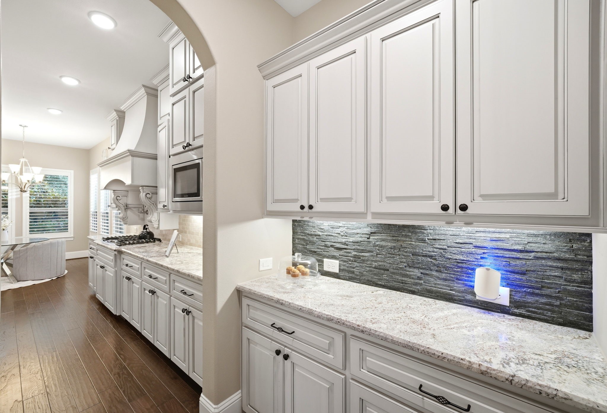 5815 Stratton Woods Drive Spring, TX 77389 - Photo 25 of 45 a kitchen with stainless steel appliances granite countertop a sink and a stove with white cabinets