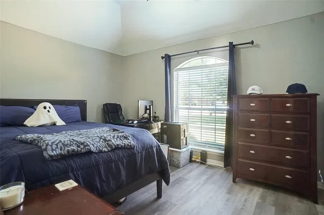 a bedroom with a bed and a dresser