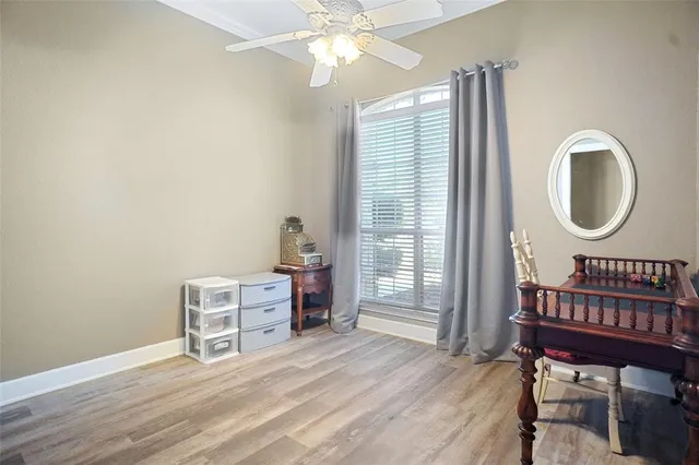 a view of a bedroom with furniture window and wooden floor