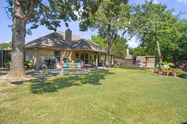 a view of outdoor space with garden and trees