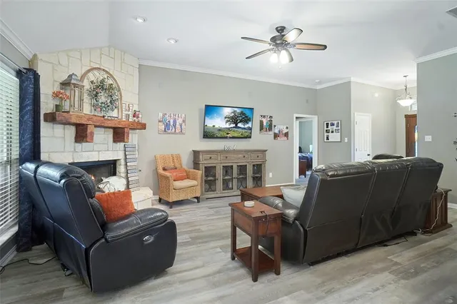 a living room with furniture a fireplace and a flat screen tv