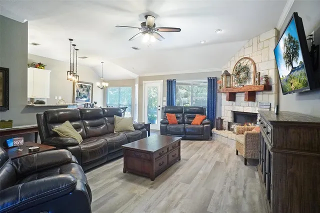 a living room with fireplace furniture and a flat screen tv