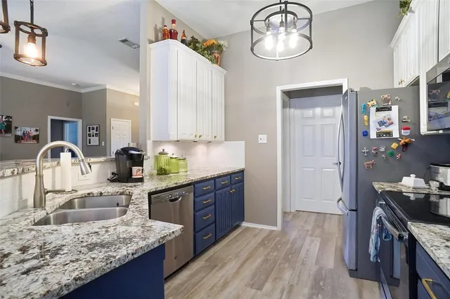 a kitchen with kitchen island granite countertop wooden cabinets and stove