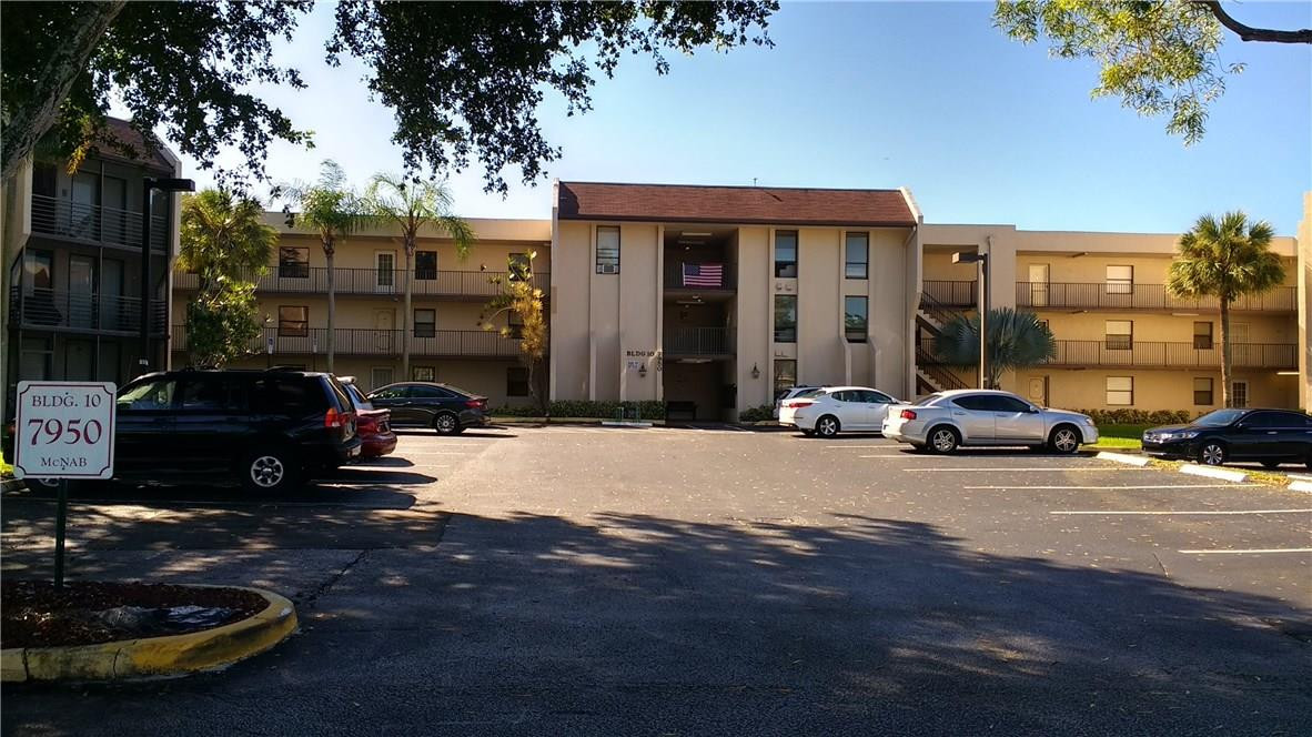 7950 West McNab Road, Unit 304 Tamarac, FL 33321 - Photo 1 of 15 a car parked in front of a building