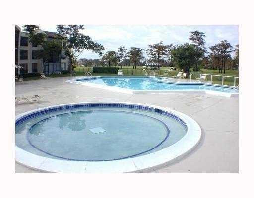 7950 West McNab Road, Unit 304 Tamarac, FL 33321 - Photo 15 of 15 a view of a swimming pool with a yard
