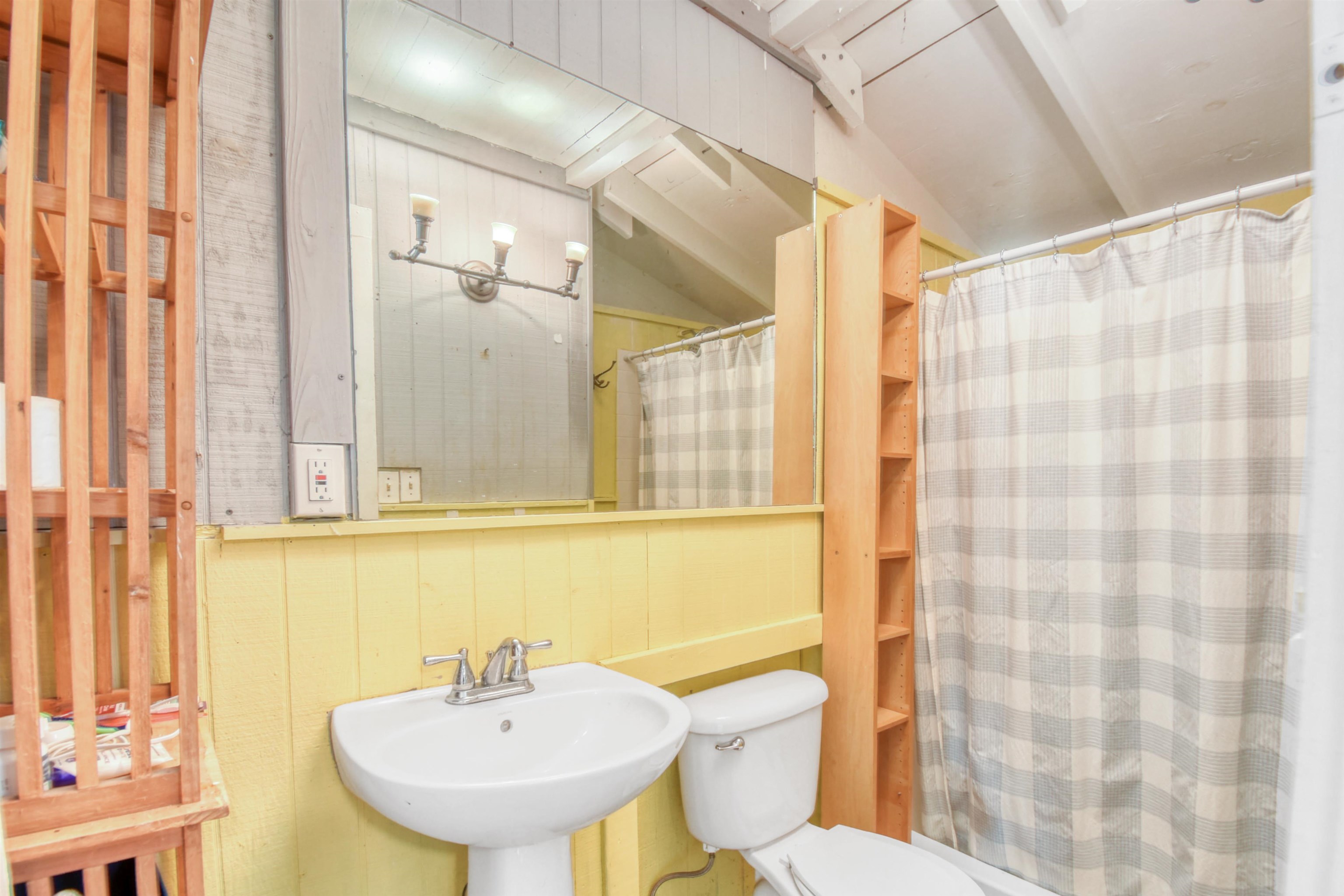 14 Rio Vista Avenue St. Augustine, FL 32084 - Photo 16 of 33 a bathroom with a sink a toilet and shower curtain