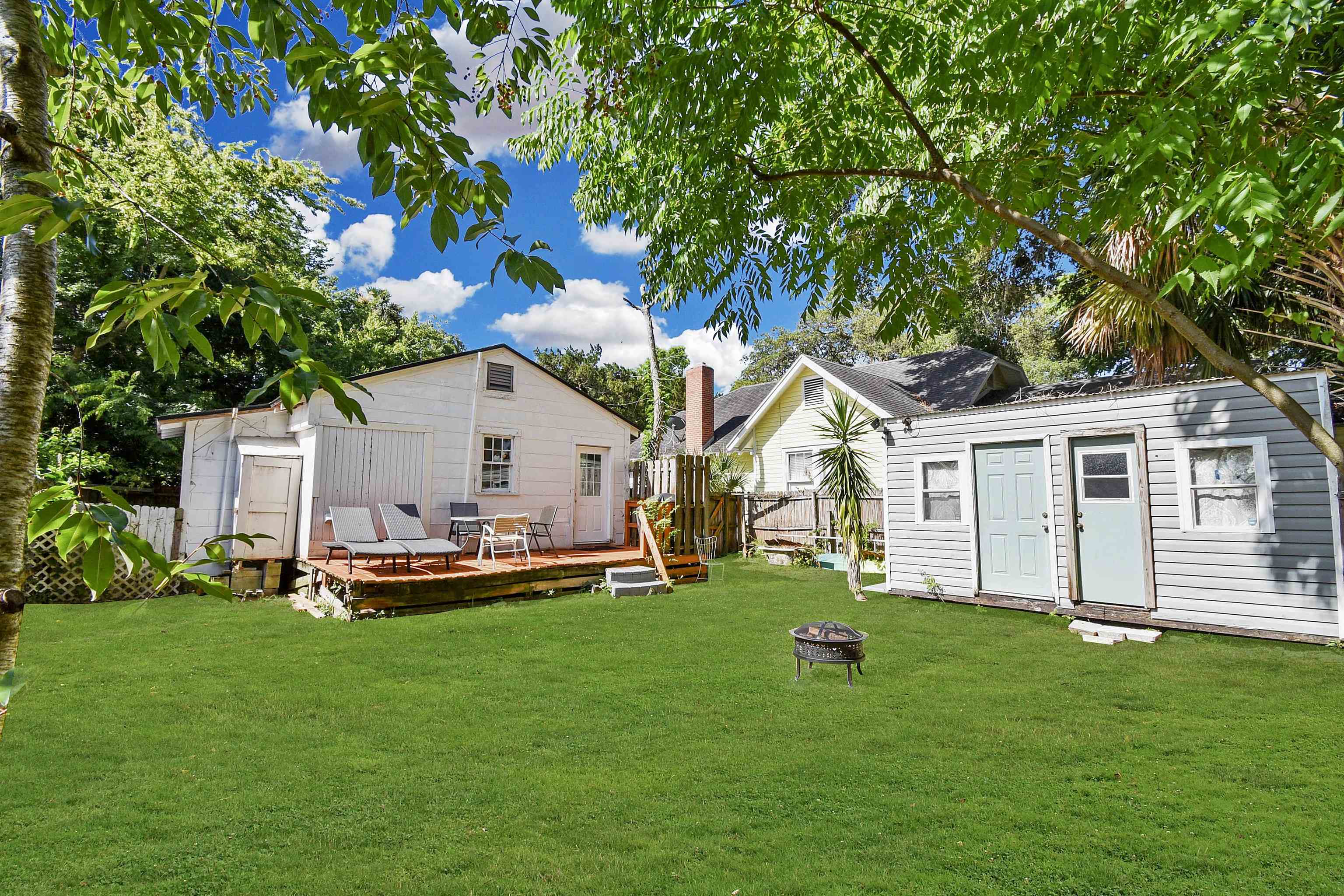 14 Rio Vista Avenue St. Augustine, FL 32084 - Photo 22 of 33 a front view of a house with a garden and trees
