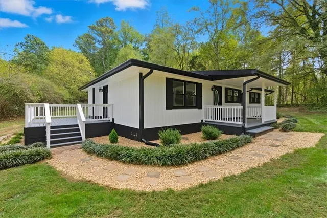 a front view of a house with a garden