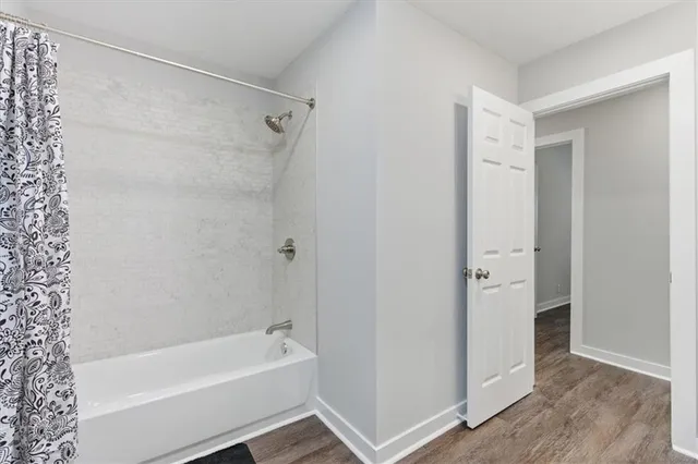 a bathroom with a bathtub and a shower