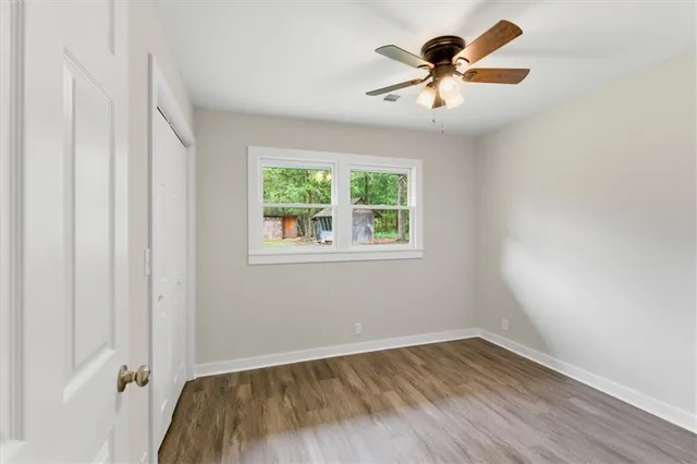 wooden floor in an empty room with a window