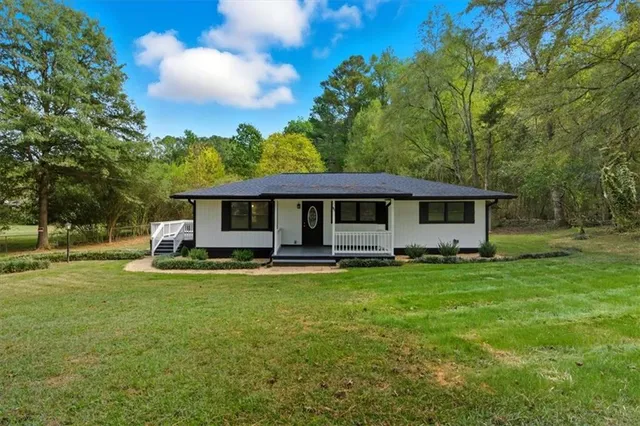 a front view of a house with a garden