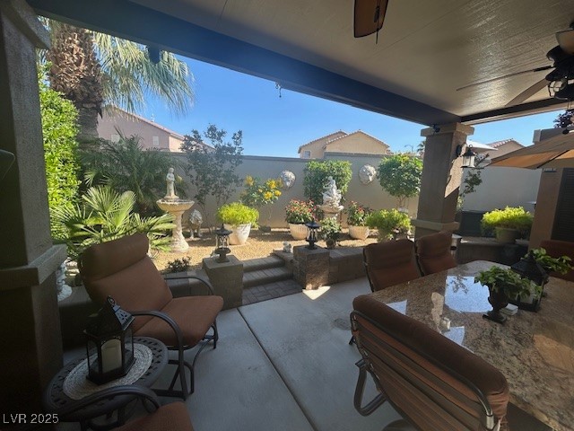 8175 Arville Street, Unit 210 Las Vegas, NV 89139 - Photo 19 of 36 Fenced backyard with a ceiling fan, a patio, and outdoor dining area