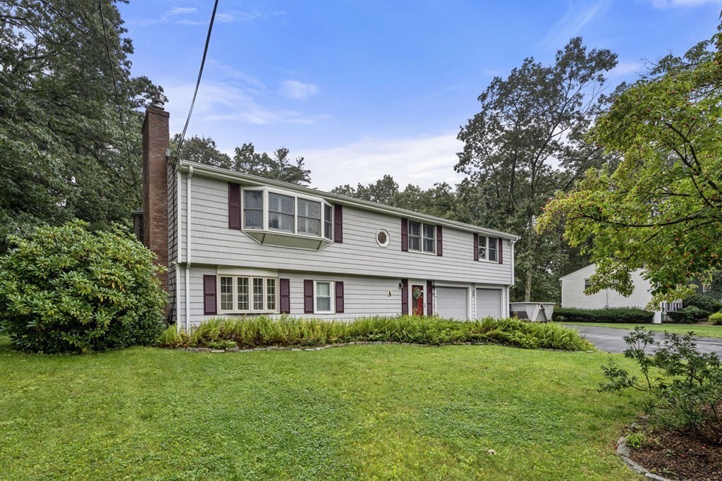 83 Pine Street Natick, MA 01760 - Photo 1 of 28 a front view of a house with a garden