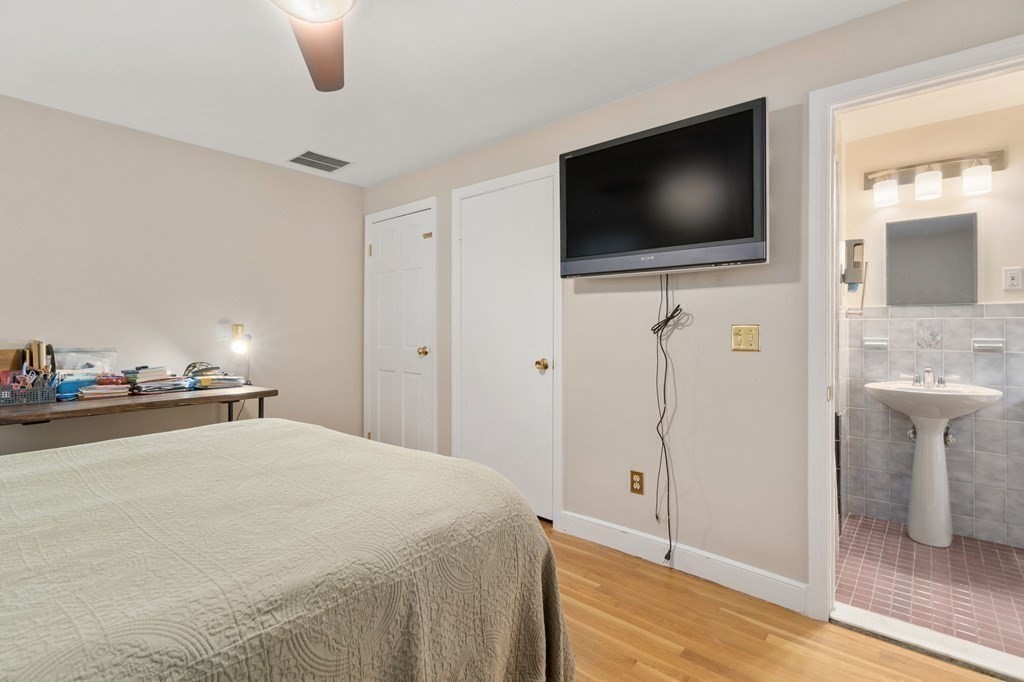 83 Pine Street Natick, MA 01760 - Photo 11 of 28 a view of a livingroom with wooden floor and a flat screen tv