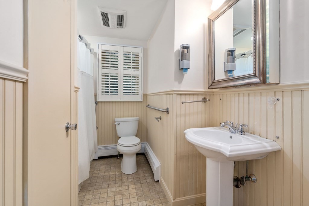 83 Pine Street Natick, MA 01760 - Photo 14 of 28 a bathroom with a sink a toilet and a mirror