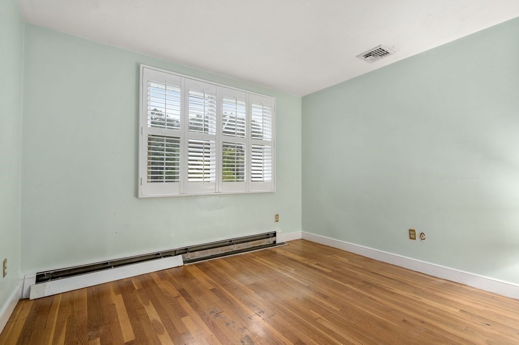 83 Pine Street Natick, MA 01760 - Photo 15 of 28 a view of a room with wooden floor and a window