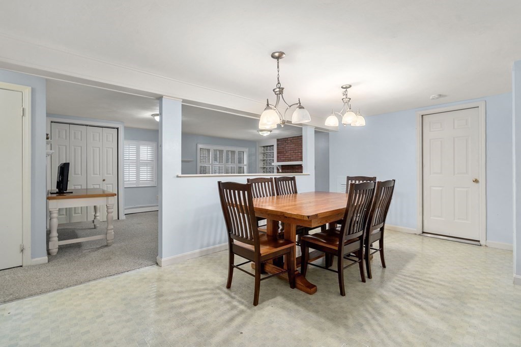 83 Pine Street Natick, MA 01760 - Photo 18 of 28 a view of a dining room with furniture and chandelier